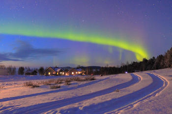 Aurora boreal y, en primer plano, las cabañas donde se alojó la expedición española (FOTO: F. Cabrerizo).