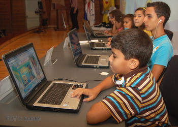 Un niño navega por internet con un ordenador portátil.