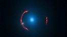 Imagen distorsionada de la galaxia mÃ¡s distante (arcos rojos) y mÃ¡s cercana (azul). Imagen: ALMA.